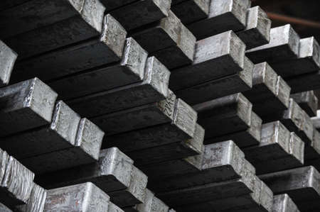 Steel billets in the warehouse of metallurgical factory. Hot ingot in a steel plant.の写真素材
