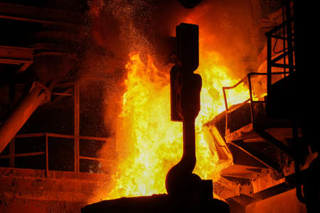Steel production in electric furnaces. Sparks of molten steel. Electric arc furnace shop EAF. Metallurgical production, heavy industry, engineering, steelmakingの写真素材