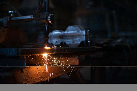 Sheet metal plate with sparking light. CNC Laser cutting of metal, modern industrial technology....
