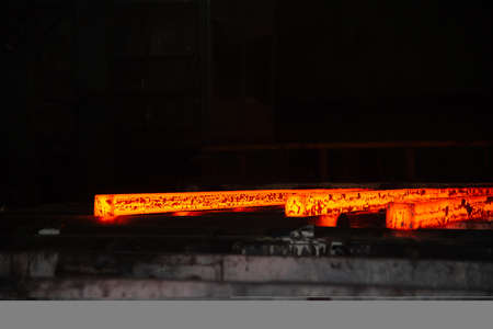 Red hot steel metal billets after molten steel casting. Background of the blacksmith and metallurgical industry.の写真素材