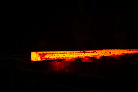 Red hot steel metal billets after molten steel casting. Background of the blacksmith and metallurgical industry.の写真素材