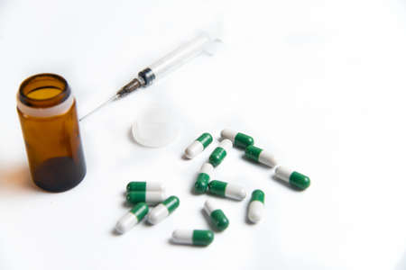 Coronavirus 2019-nCoV outbreak. Pills and syringe on a white isolated background.の写真素材