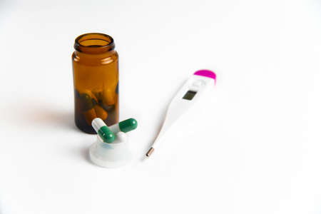 Coronavirus 2019-nCoV outbreak. Pills and thermometer on a white isolated backgroundの写真素材