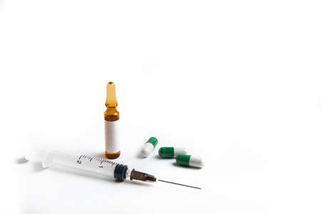 Coronavirus 2019-nCoV outbreak. Pills and syringe on a white isolated backgroundの写真素材