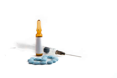 Coronavirus 2019-nCoV outbreak. Pills and syringe on a white isolated background.の写真素材