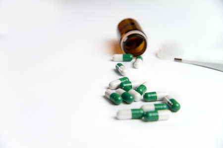 Coronavirus 2019-nCoV outbreak. Pills and thermometer on a white isolated backgroundの写真素材