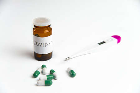 Coronavirus 2019-nCoV outbreak. Pills and thermometer on a white isolated background