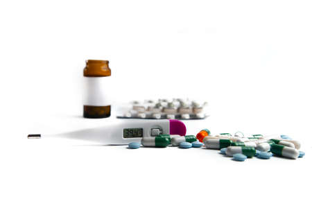 Coronavirus 2019-nCoV outbreak. Pills and drug, care during illness. Thermometer on a white isolated...