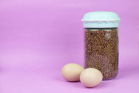 Food stock for quarantine isolation period on purple background. Egg and buckwheat. Food delivery, Donation. Copyspaceの写真素材