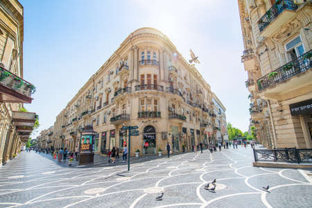 Baku, Azerbaijan â April 29, 2020: Pigeons on the pavement of Nizami street in the center of Baku, Azerbaijan. Nizami street - large pedestrian and shopping street. Pigeons in urban environment.のeditorial素材