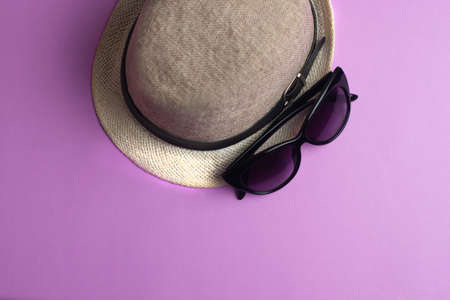Summer accessories, hat and sun glasses on violet background. Summer concept.の写真素材