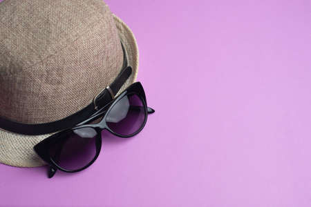 Summer accessories, hat and sun glasses on pink background. Summer concept.の写真素材