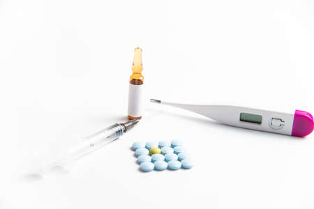 Coronavirus 2019-nCoV outbreak. Pills, thermometer and syringe on a white isolated background.の写真素材
