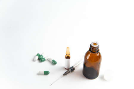 Coronavirus 2019-nCoV outbreak. Pills and syringe on white isolated background. Pills and drug, care...