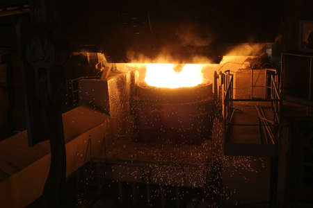 Steel production in electric furnaces. Sparks of molten steel. Electric arc furnace shop EAF....