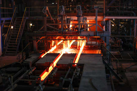 Red hot steel metal billets after molten steel casting.  Continuous casting machine. Background of the blacksmith and metallurgical industry.の写真素材
