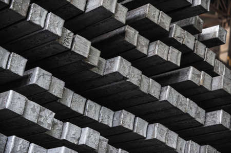 Steel billets in the warehouse of metallurgical factory. Hot ingot in a steel plant.の写真素材
