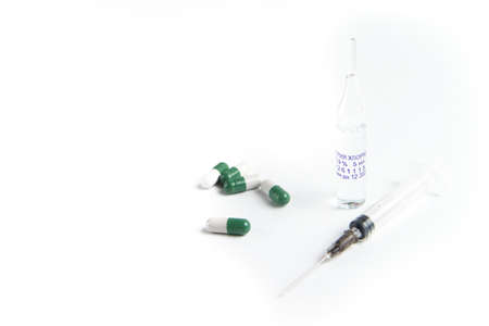 Coronavirus 2019-nCoV outbreak. Pills and syringe on white isolated background. Pills and drug, care during illness.の写真素材