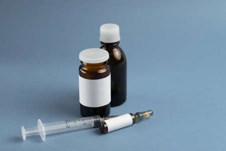 Coronavirus 2019-nCoV outbreak. Pills and syringe on blue background. Pills and drug, care during illness.の写真素材