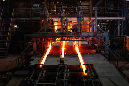 Red hot steel metal billets after molten steel casting.  Continuous casting machine. Background of the blacksmith and metallurgical industry.の写真素材