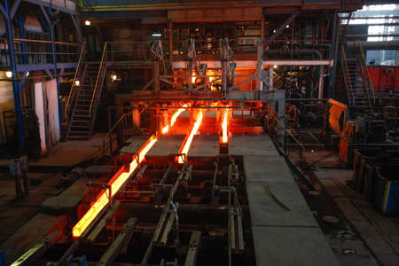 Red hot steel metal billets after molten steel casting.  Continuous casting machine. Background of the blacksmith and metallurgical industry.の写真素材