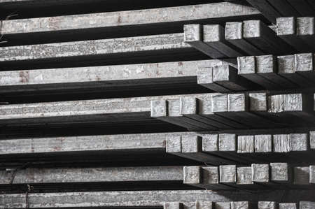 Steel billets in the warehouse of metallurgical factory. Hot ingot in a steel plant.の写真素材