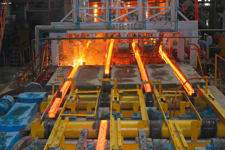 Red hot steel metal billets after molten steel casting.  Continuous casting machine. Background of the blacksmith and metallurgical industry.の写真素材