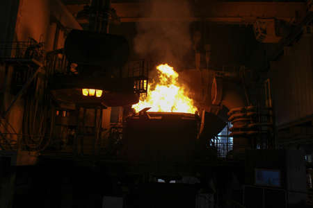Steel production in electric furnaces. Sparks of molten steel. Electric arc furnace shop EAF. Metallurgical production, heavy industry, engineering, steelmaking.の写真素材