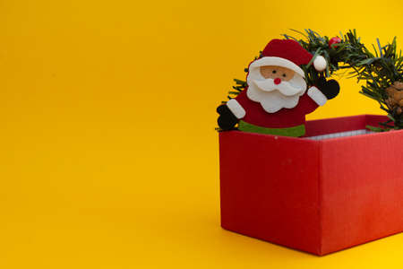 Happy New Year and Merry Christmas. Santa Claus with holiday present. Copy space, yellow background, space for text.の写真素材