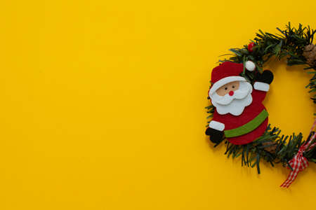 Happy New Year and Merry Christmas. Santa Claus with holiday present. Copy space, yellow background, space for text.の写真素材