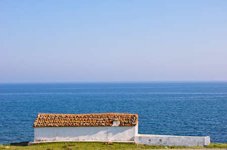 Small white greek church in sea side in Gokceada Turkeyの写真素材