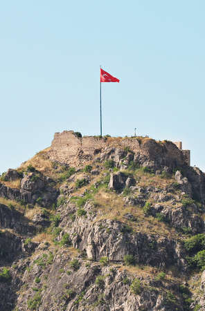 Turkish flag waving in the mountains on the border of Syria and Turkey in Sanliurfa, Turkeyの写真素材