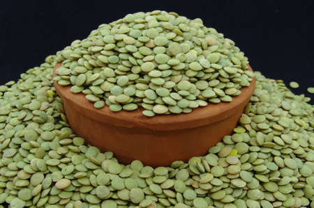 Green lentils in pottery bowlの写真素材