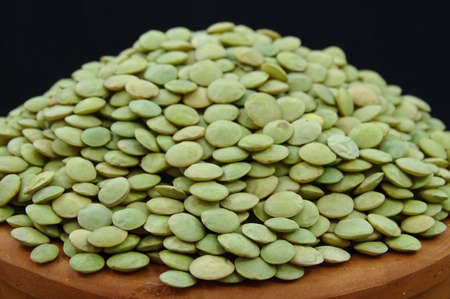 Green lentils in pottery bowlの写真素材