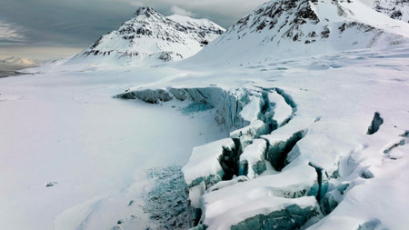 icecaps in the Antarctica with iceberg in the ocean swimming around and melting in the seaのeditorial素材