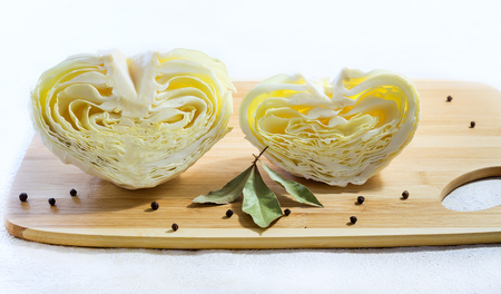 Halves of cabbage in shape of hearts. Creative food concept. Light backgroundの写真素材