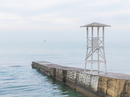 White wooden rescue tower on the breakwater. Seascape in soft blue tonesの写真素材