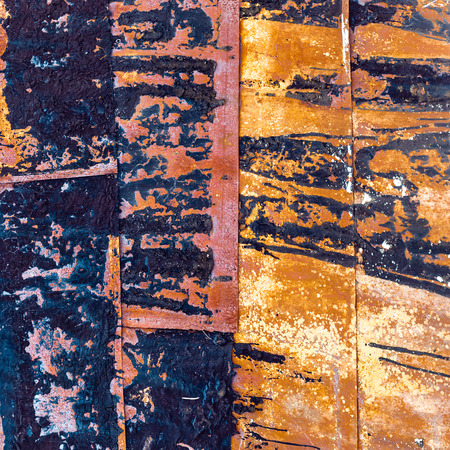 Metal sheets with peeling and burned paint. Abstract background. Spotted patternの写真素材