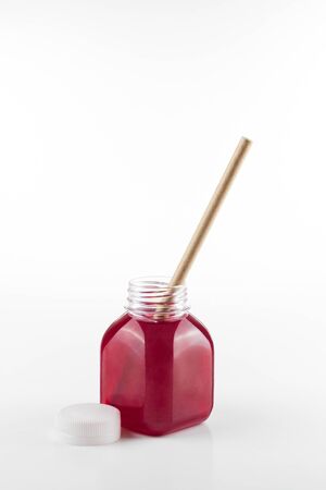 Plastic bottle of fresh fruit drink with craft paper straw on white background.
Vertical formatの写真素材