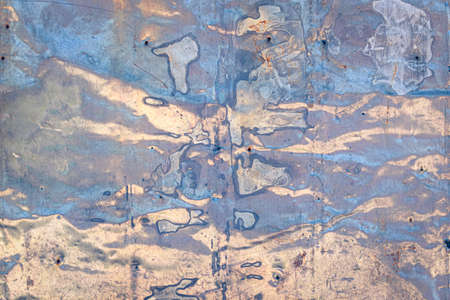 Streaks of blue and beige paint on iron sheet. Abstract spotted patterned background.の写真素材