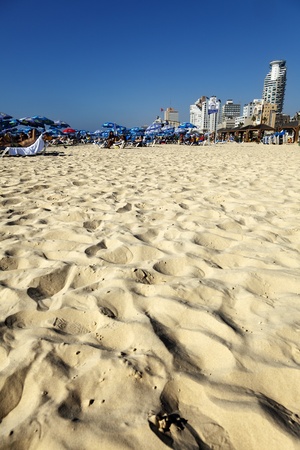 Tel-Aviv, Israel - September 3rd, 2011: View looking north at the Tel-Aviv beach and hotels strip on a clear day; packed with thousands of people either sunbathing or hiding in a parasol's shade.のeditorial素材