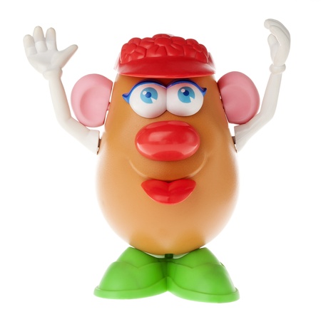 Tel-Aviv, Israel - January 25th, 2012: Isolated on white studio shot of the famous toy Mr. Potato Head, by the Hasbro company.This time it is actually a mrs., or miss potato head. She is looking slightly above the camera, raising her arms in a cheer and のeditorial素材