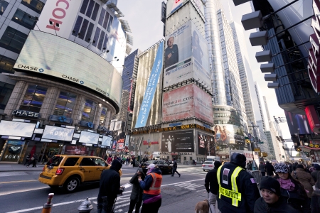 New-York, USA - November 6th, 2012: Pedestrians waiting on the sidewalk while cars rush down the...