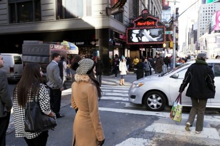 New-York, USA - November 6th, 2012: Pedestrians waiting on the sidewalk while cars rush down the street at Times Square in Manhattan at autumn noon.のeditorial素材