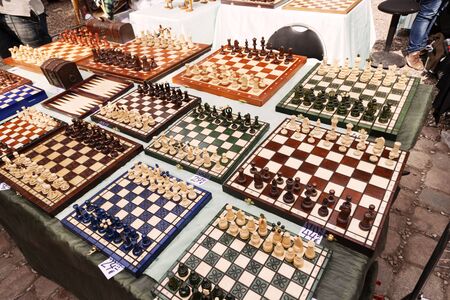 Berlin, Germany - June 10th, 2012:  High angle view of a large amount of homemade chess boards displayed for sale on a table at the Mauerpark sunday flea market.のeditorial素材