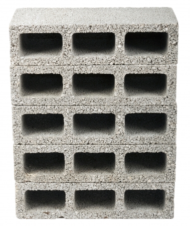 Five gray concrete construction blocks (a.k.a. cinder block, breeze block, cement block, foundation block, besser block; professional term: Concrete Masonary Unit - CMU) in a straight stack, isolated on white background.の写真素材