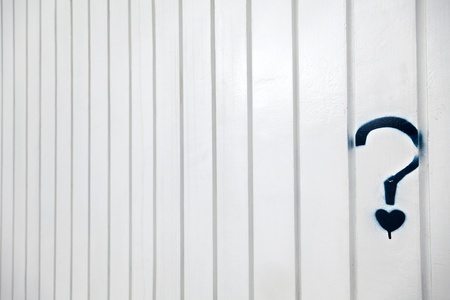 A blue grafitti in the shape of a question mark with a small heart instead of the dot, on a white...