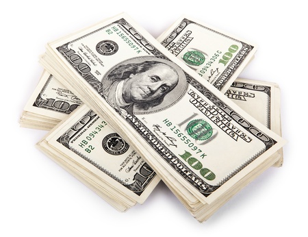 Three stacks of 100 US$ money notes on top of eachother, isolated on white background.