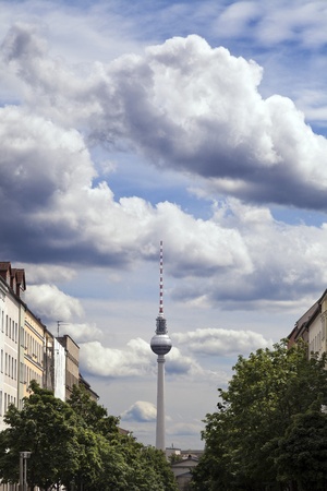 View of the blocks of buildings that stretch along Strelitzer strasse and the Berlin Television Tower  Fernsehturm  in the distance, beneath blue cloudy sky のeditorial素材