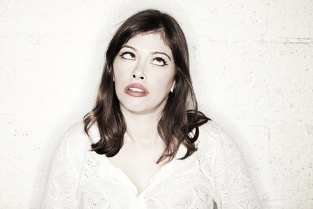 Portrait of a beautiful young woman with a very peculiar cross-eyed sneering facial expression.の写真素材